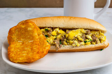 scramble  egg and sausage sub  with hash browns