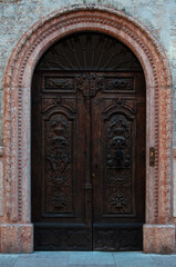 old wooden door and carvings, Italy city of Trento