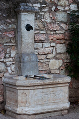 vintage fountain with drinking water in a public park in Italy