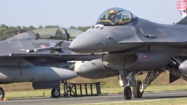 fighter jet seen taxiing airbase taxiway moving towards runway while preparing for combat mission pilot be saluting professionalism close up ready war military operation action aviation 