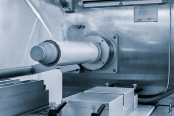 Automatic polyethylene plastic bag production machine with lighting effect. Close-up of the roller...