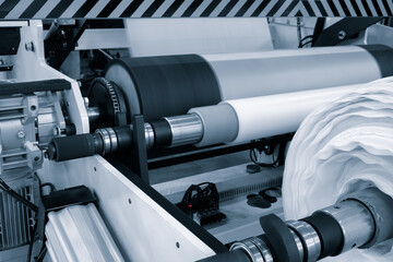 Automatic polyethylene plastic bag production machine with lighting effect. Close-up of the roller...