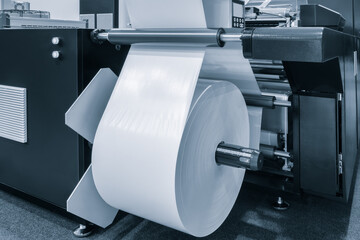 Automatic polyethylene plastic bag production machine with lighting effect. Close-up of the roller...