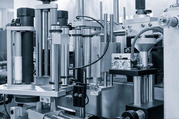 Fragment of the conveyor of sticking labeling machine. Abstract industrial background.