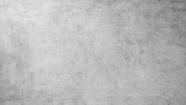 A grey wall with a grey background. The wall is made of concrete and has a rough texture white gray rough texture background as banner
