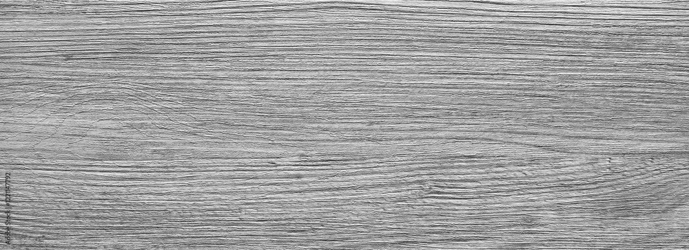 Poster A wooden surface with a grainy texture. The wood is grey and has a rough appearance. The surface is not smooth and has a lot of texture