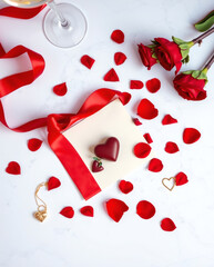 Romantic celebration with heart-shaped chocolate, rose petals, and elegant decor for a special occasion