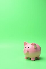A Pink Piggy Bank on a Vibrant Green Background, Representing Savings and Financial Security