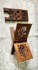 Fototapeta na wymiar Two Quran stands and books made of wood are more comfortable to read, both during Ramadan and when reciting the Koran