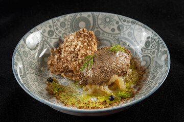 Goose liver pate on a plate of breads. With fried onions, on a beautiful plate. 45 view