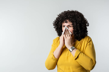 Woman with allergy symptom blowing nose