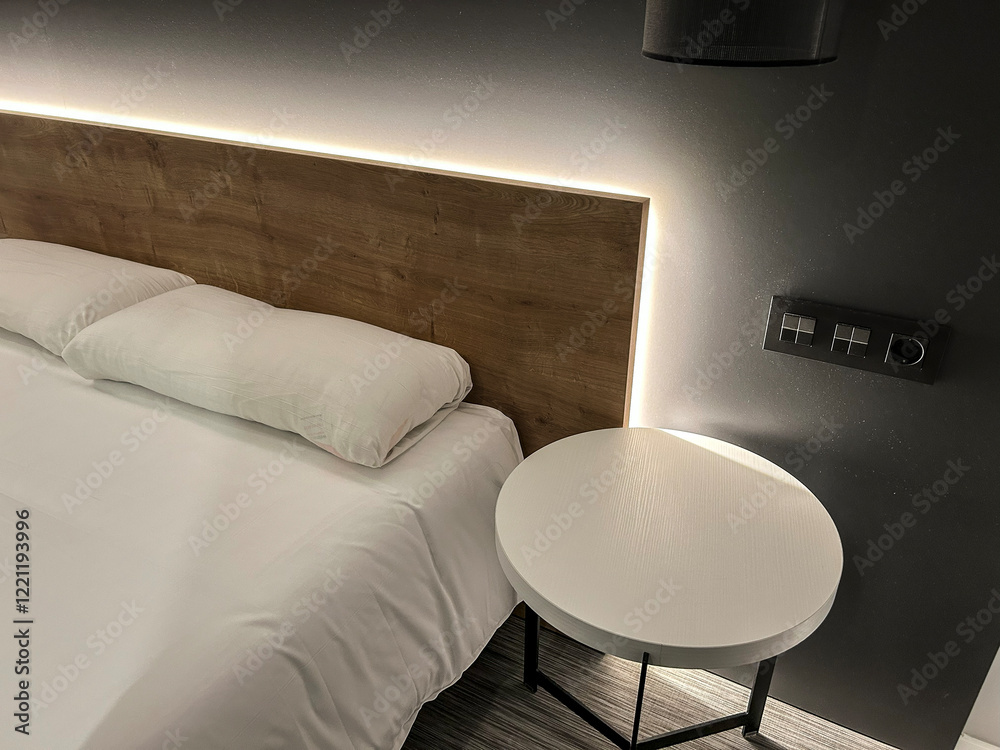 Wall mural Modern hotel room interior design with illuminated wooden headboard