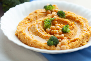 Delicious sweet potato hummus topped with chickpeas and broccoli florets. A healthy and flavorful snack or appetizer.