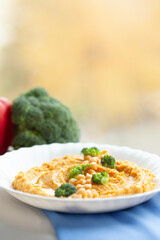 Creamy hummus with chickpeas and broccoli florets. A healthy and delicious meal or snack.