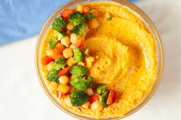Creamy mashed sweet potato topped with chickpeas, broccoli, and bell peppers. A healthy and delicious vegetarian meal.
