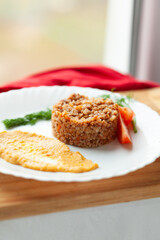 Hearty buckwheat dish with a side of creamy puree and fresh vegetables. A simple yet satisfying meal.
