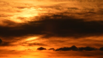 Cloudscape at extremely hot evening. Summer heat alert. Dark red sunset sky with bleeding red clouds. Dramatic view of a new scorch day in North America and heat wave.