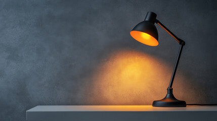 Elegant desk lamp softly illuminates a white table against a grey backdrop creating a warm atmosphere