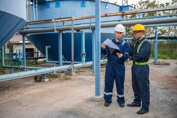Engineer and technician maintenance checking technical data of system equipment Condenser Water pump and pressure gauge,environmentalist working at water supply