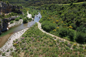 Viewed from the village of Minerve, the Cesse river is crossed by a footpath (Hérault, Occitanie, France)