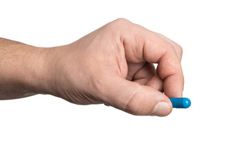 Fototapeta premium Male hand holding blue medicine capsule, antibiotic pill, or painkiller, isolated on transparent background. healthcare and treatment concept