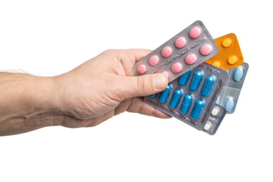 Male hand holding various blister packs with medicine capsules, antibiotic pills, or painkillers, isolated on transparent background. healthcare and treatment concept