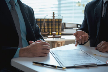 Lawyers discussing contract terms during meeting in office