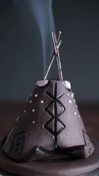 Rotating ceramic incense holder with smoke in teepee design