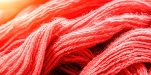 Close-up of red wool yarn fibers texture in soft focus