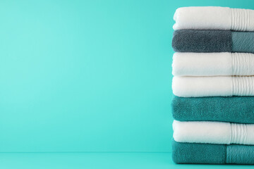 Soft towels stacked neatly in calming turquoise color scheme for relaxation