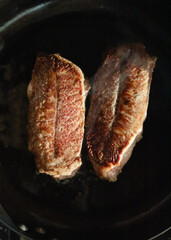 marbled beef steak, top blade steak in a frying pan