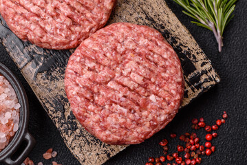 Fresh raw ground beef burger patty with salt and spices