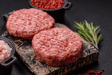 Fresh raw ground beef burger patty with salt and spices