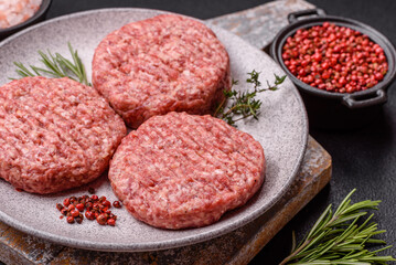 Fresh raw ground beef burger patty with salt and spices