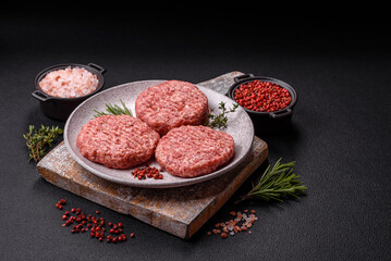 Fresh raw ground beef burger patty with salt and spices