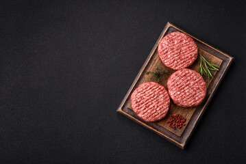 Fresh raw ground beef burger patty with salt and spices