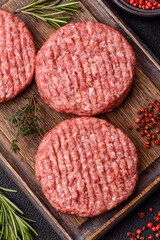 Fresh raw ground beef burger patty with salt and spices