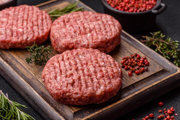 Fresh raw ground beef burger patty with salt and spices