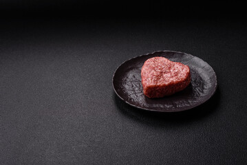 Raw beef or pork burger patty in the shape of a heart