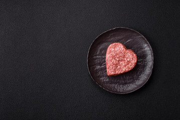 Raw beef or pork burger patty in the shape of a heart