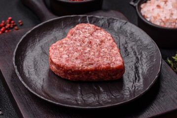 Raw beef or pork burger patty in the shape of a heart