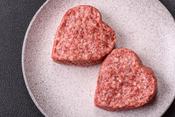 Raw beef or pork burger patty in the shape of a heart