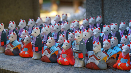 Kyoto, Japan - Sep 23 2024, A close-up view of the many small figures of white kitsune foxes...