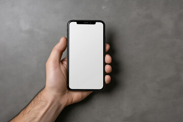 Hand holding a smartphone on a dark textured surface in a minimalist setup