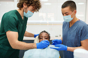Diverse Dentists Preparing Dental Cement for Procedure