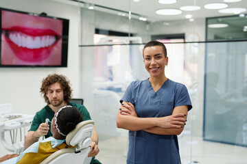 Cheerful Female Dentist Assistant in Modern Clinic
