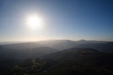 Sun shining on a beautiful mountain landscape on top of a hike trip in Girona, Catalonia