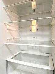 Fototapeta premium Open empty white refrigerator, view with the door open