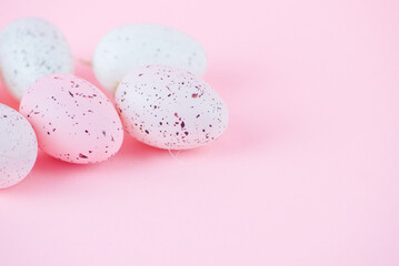 Easter pink background with bright colored eggs and space for text