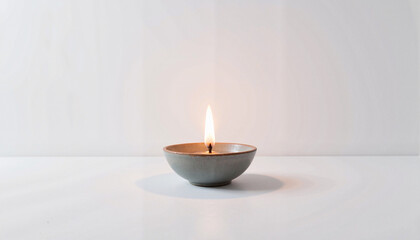 Serene candle flame illuminating minimalist background, inner peace